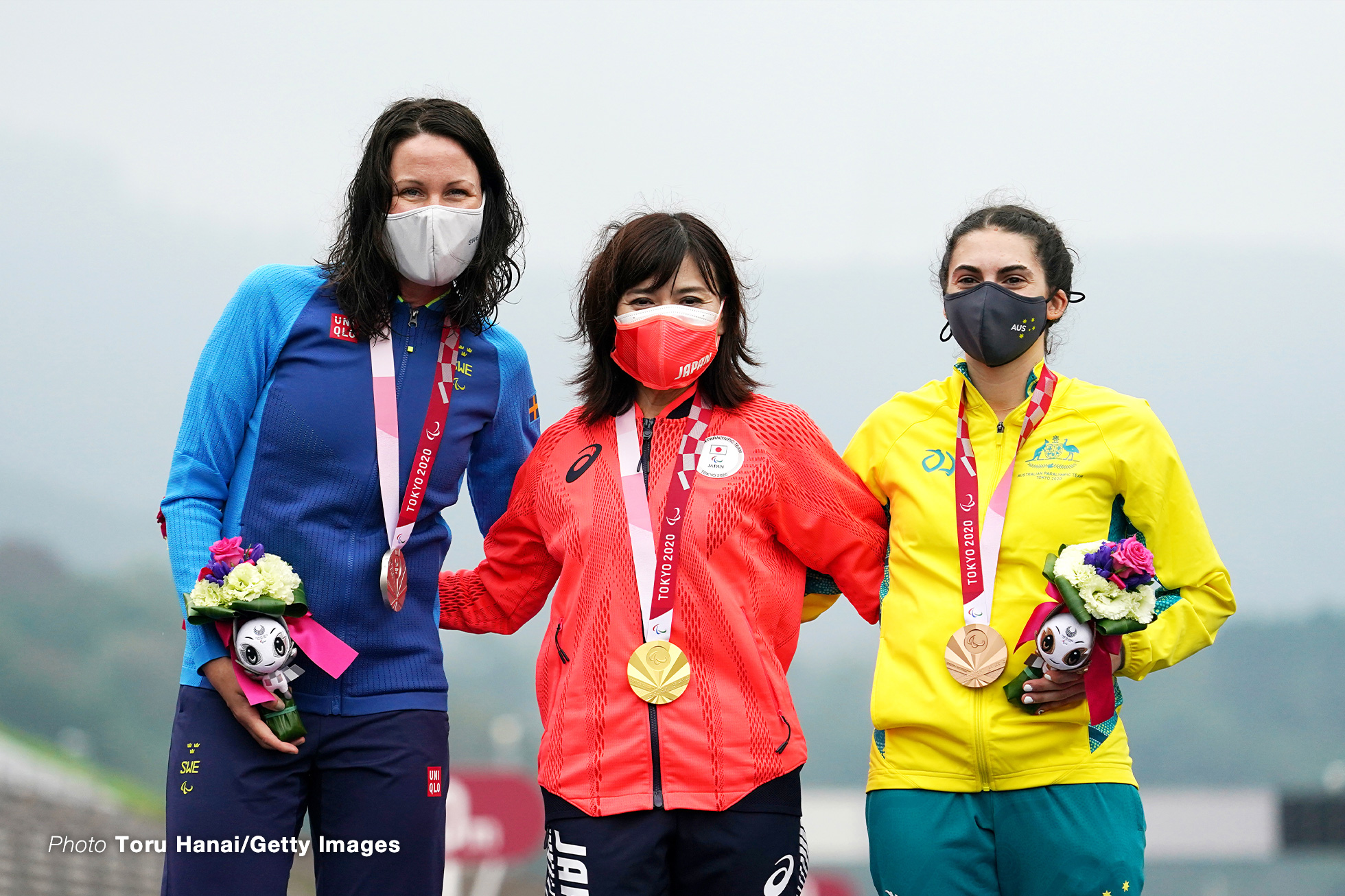 OYAMA, JAPAN - AUGUST 31: (L-R) Silver medalist Anna Beck of Team Sweden, gold medalist Keiko Sugiura of Team Japan and bronze medalist Paige Greco of Team Australia pose on the podium at the medal ceremony for the Cycling Road Women's C1-3 Time Trial on day 7 of the Tokyo 2020 Paralympic Games at Fuji International Speedway on August 31, 2021 in Oyama, Japan. (Photo by Toru Hanai/Getty Images)