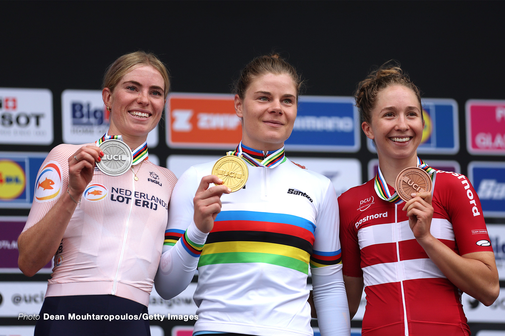 GLASGOW, SCOTLAND - AUGUST 13: Silver medalist Demi Vollering of The Netherlands, gold medalist Lotte Kopecky of Belgium and bronze medalist Cecilie Ludwig of Denmark pose on the podium during the medal ceremony after the Women Elite & Women U23 Road Race a 154.1km race from Loch Lomond to Glasgow at the 96th UCI Cycling World Championships Glasgow 2023, Day 11 /#UCIWWT / on August 13, 2023 in Glasgow, Scotland. (Photo by Dean Mouhtaropoulos/Getty Images)