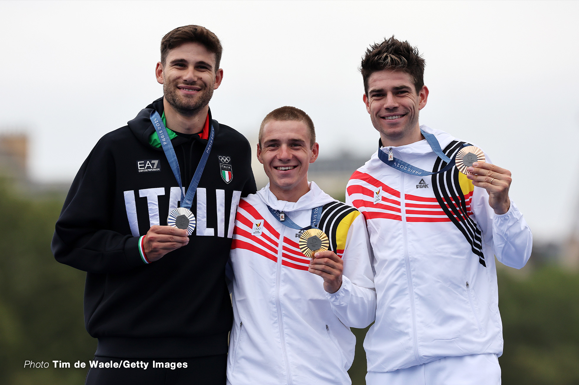 PARIS, FRANCE - JULY 27: Gold medalist Remco Evenepoel of Team Belgium (C), Silver medalist Filippo Ganna of Team Italy (L) and Bronze medalist Wout van Aert of Team Belgium (R) pose on the podium at the Pont Alexandre III, during the Men's Individual Time Trial on day one of the Olympic Games Paris 2024 at Pont Alexandre III on July 27, 2024 in Paris, France. (Photo by Tim de Waele/Getty Images)