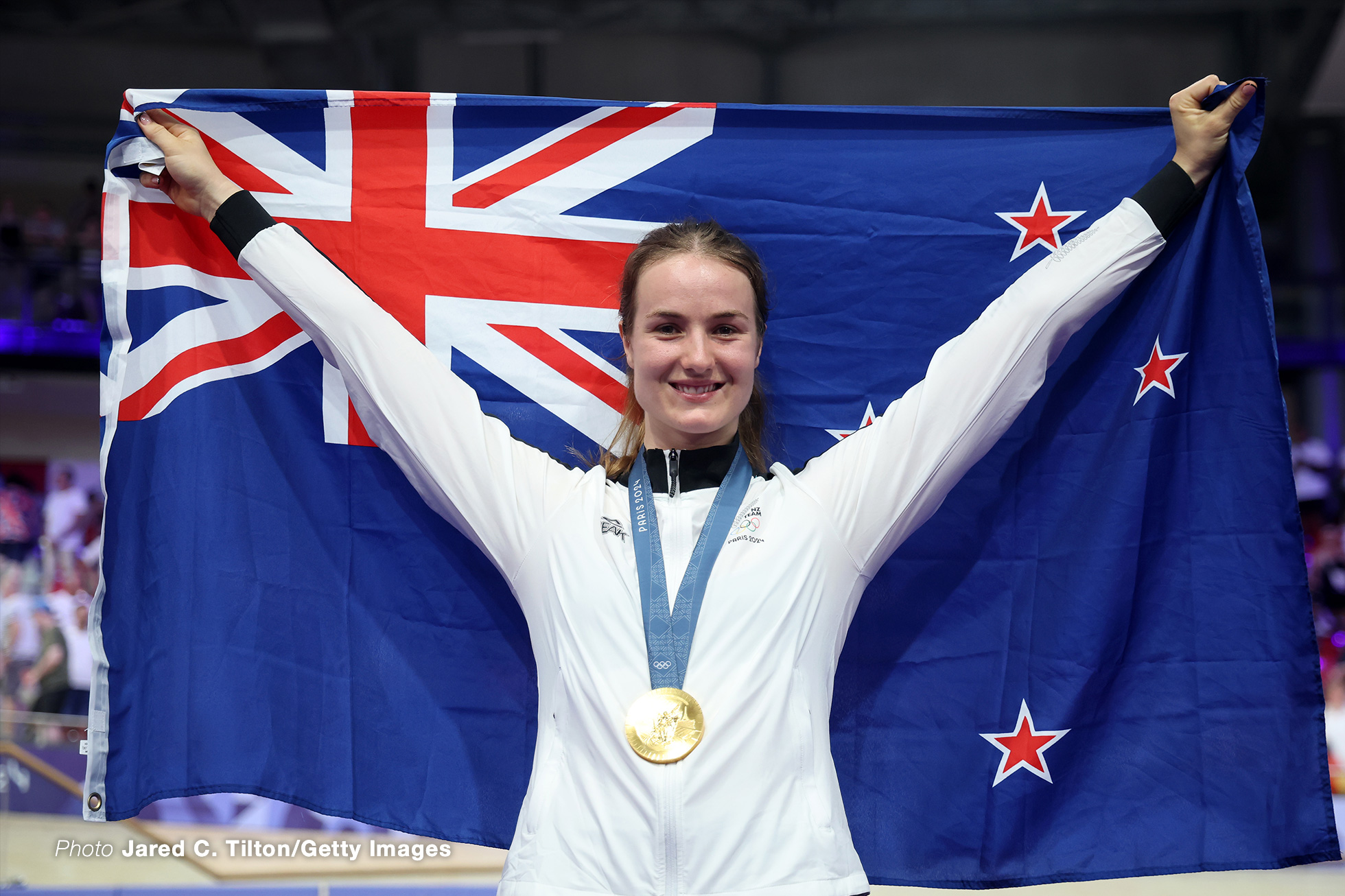 PARIS, FRANCE - AUGUST 11: Gold medalist Ellesse Andrews of Team New Zealand celebrates on the podium after the Women's Sprint, Finals on day sixteen of the Olympic Games Paris 2024 at Saint-Quentin-en-Yvelines Velodrome on August 11, 2024 in Paris, France. (Photo by Jared C. Tilton/Getty Images)