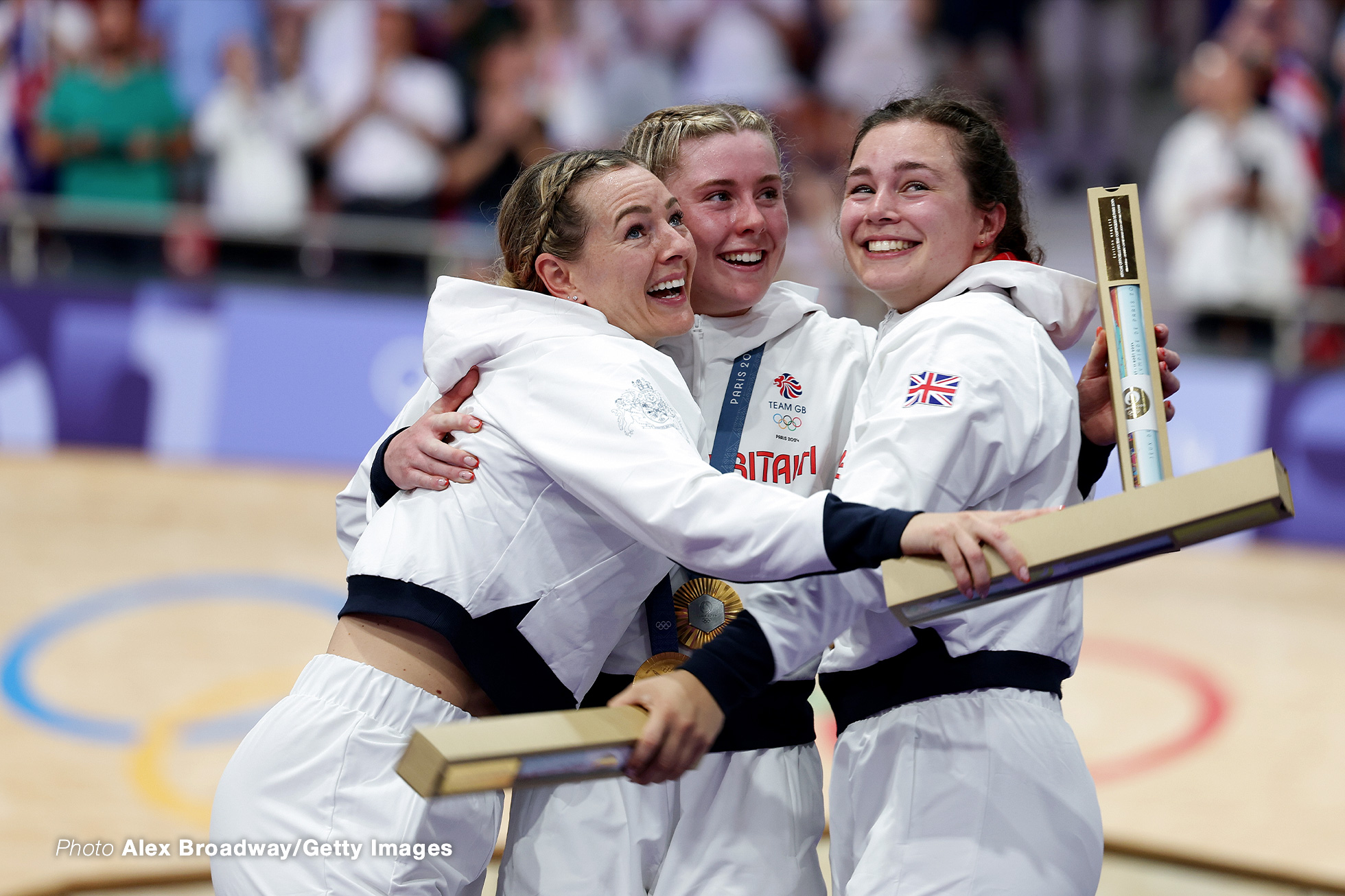 PARIS, FRANCE - AUGUST 05: Gold medalists Katy Marchant, Sophie Capewell and Emma Finucane of Team Great Britain celebrate on the podium during the Women’s Team Sprint, Finals on day ten of the Olympic Games Paris 2024 at Saint-Quentin-en-Yvelines Velodrome on August 05, 2024 in Paris, France. (Photo by Alex Broadway/Getty Images)