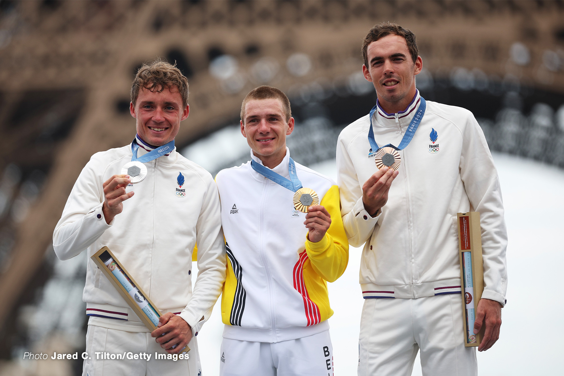 PARIS, FRANCE - AUGUST 03: Gold medalist Remco Evenepoel of Team Belgium (C), Silver medalist Valentin Madouas of Team France (L) and Bronze medalist Christophe Laporte of Team France (R) pose on the podium during the Men's Road Race on day eight of the Olympic Games Paris 2024 at trocadero on August 03, 2024 in Paris, France. (Photo by Jared C. Tilton/Getty Images)